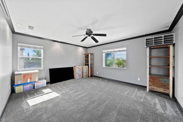 unfurnished living room with a ceiling fan, ornamental molding, visible vents, carpet floors, and baseboards