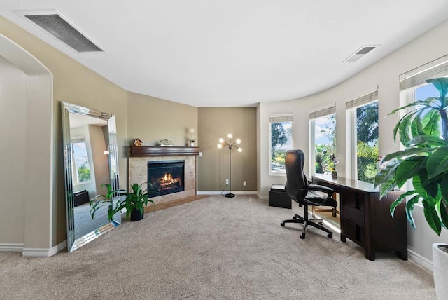 home office with a fireplace with flush hearth, baseboards, carpet, and visible vents