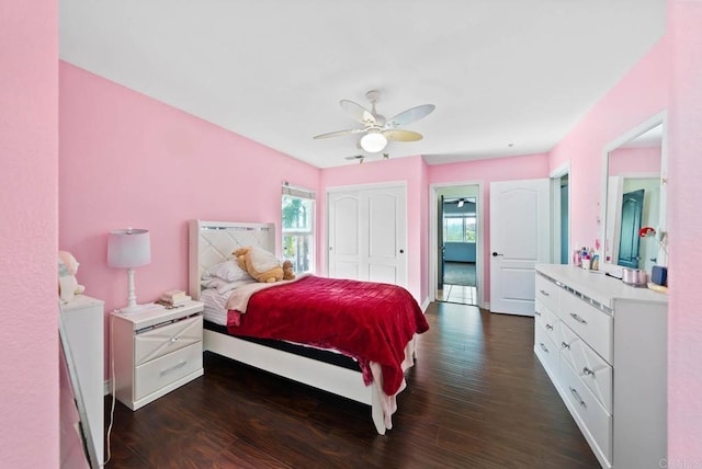bedroom featuring dark wood-style floors, baseboards, and a ceiling fan