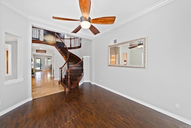 unfurnished room with baseboards, crown molding, stairs, visible vents, and ceiling fan