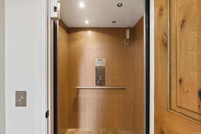 interior details featuring recessed lighting and elevator