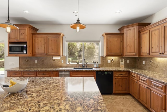 kitchen with a sink, black dishwasher, brown cabinetry, decorative backsplash, and stainless steel microwave