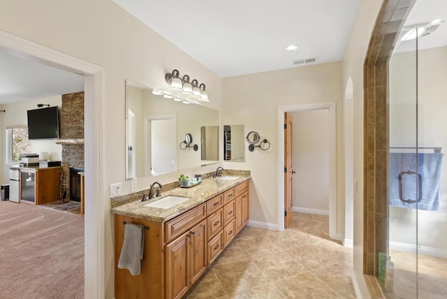 full bathroom featuring double vanity, baseboards, visible vents, and a sink