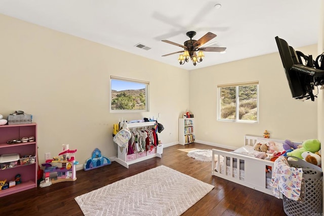 playroom featuring visible vents, ceiling fan, baseboards, and hardwood / wood-style flooring