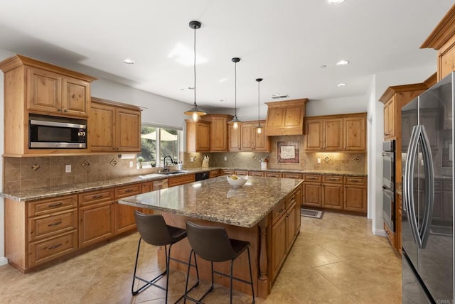 6433 Dehesa Rd, El Cajon, CA 92019 - kitchen with brown cabinets, a kitchen island, stainless steel appliances, and a sink