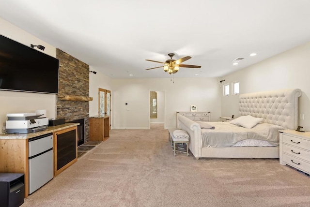 6433 Dehesa Rd, El Cajon, CA 92019 - bedroom featuring a stone fireplace, visible vents, refrigerator, light colored carpet, and ceiling fan