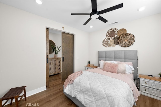 bedroom with baseboards, visible vents, a ceiling fan, wood finished floors, and recessed lighting