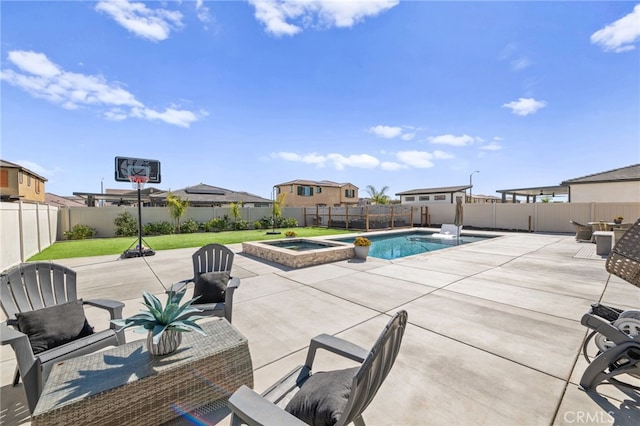 view of pool with a pool with connected hot tub, a fenced backyard, a patio, and a lawn