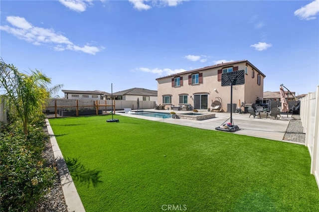 view of yard featuring a patio area, a fenced backyard, and a pool with connected hot tub