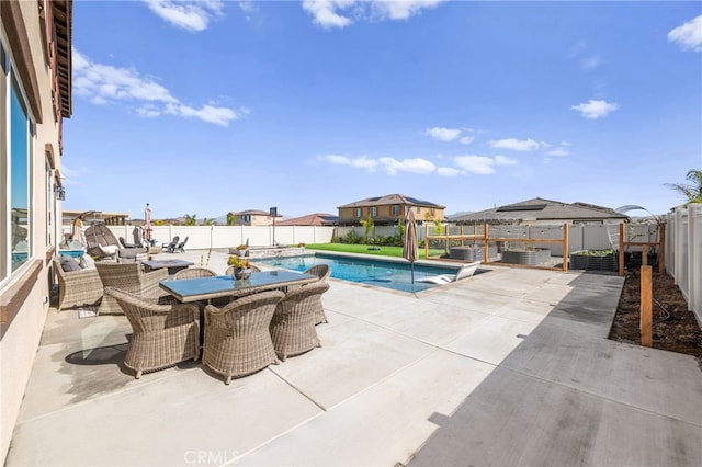 view of swimming pool with a fenced in pool, outdoor dining space, a patio area, and a fenced backyard