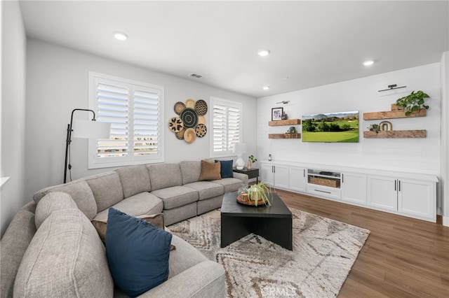 living area featuring wood finished floors, visible vents, and recessed lighting