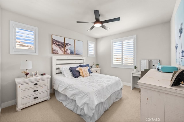 bedroom with baseboards, ceiling fan, and light colored carpet