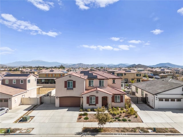 view of front of property with a residential view, fence, and a mountain view