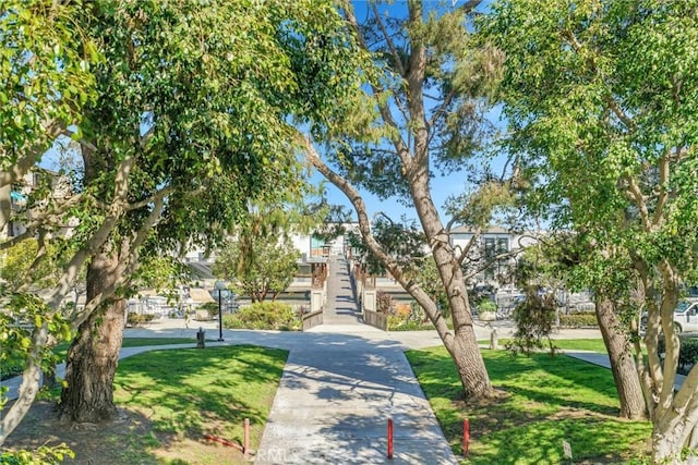 view of home's community with a yard and stairway