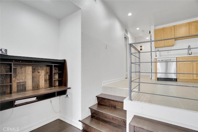 staircase with recessed lighting, baseboards, and wood finished floors