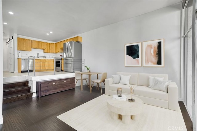 living area with dark wood-style floors and recessed lighting