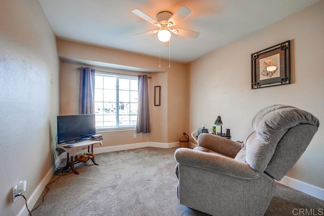 sitting room featuring a ceiling fan, carpet flooring, and baseboards