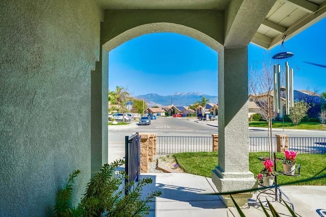 exterior space featuring fence and a mountain view