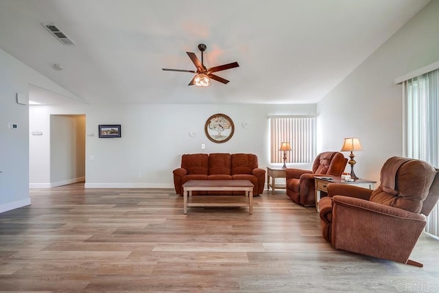 living room featuring ceiling fan, light wood-type flooring, visible vents, and baseboards