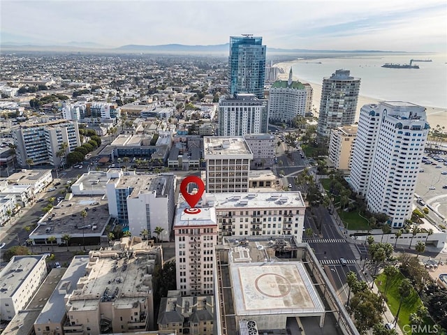 drone / aerial view featuring a view of city and a water view