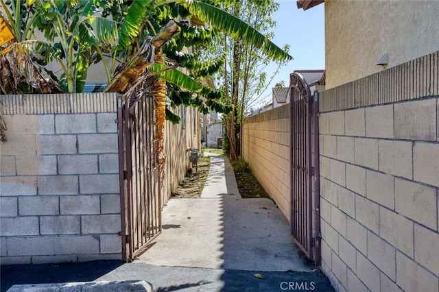 view of side of home with a gate and fence