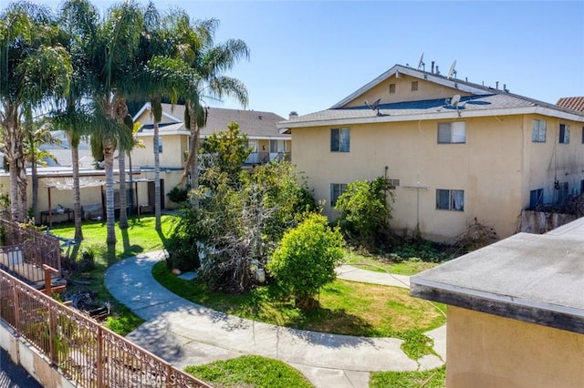 exterior space with a lawn and fence