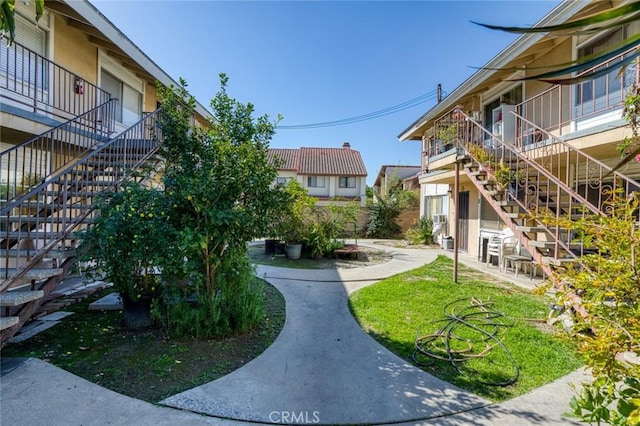 surrounding community with stairs and a lawn