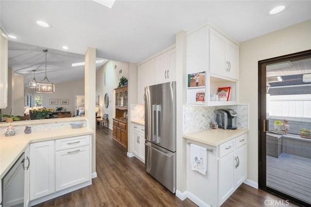 kitchen featuring white cabinets, dark wood finished floors, decorative backsplash, stainless steel appliances, and light countertops