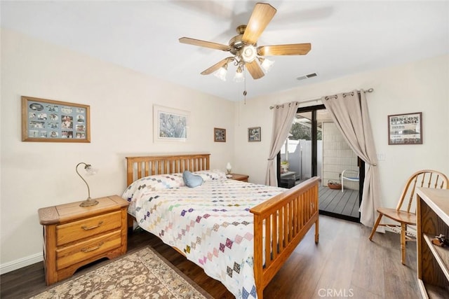 bedroom with wood finished floors, a ceiling fan, baseboards, visible vents, and access to exterior