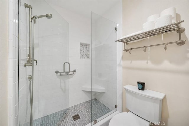 full bath with a stall shower and toilet