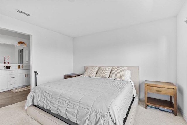 bedroom featuring visible vents and connected bathroom