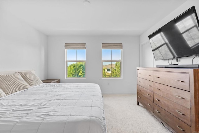 bedroom featuring light carpet