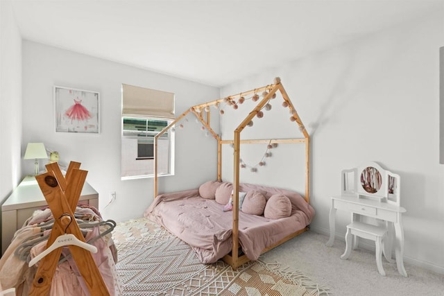 carpeted bedroom featuring baseboards