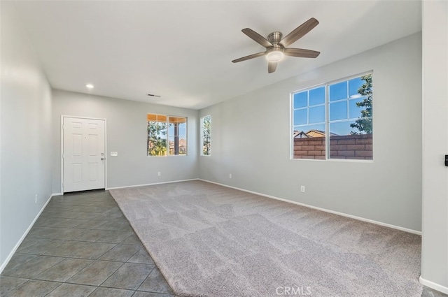 carpeted empty room featuring ceiling fan, baseboards, tile patterned flooring, and recessed lighting