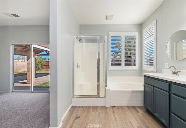 full bath featuring a garden tub, a shower stall, visible vents, and vanity