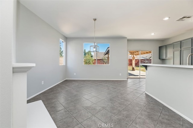 unfurnished dining area featuring recessed lighting, visible vents, baseboards, and tile patterned floors