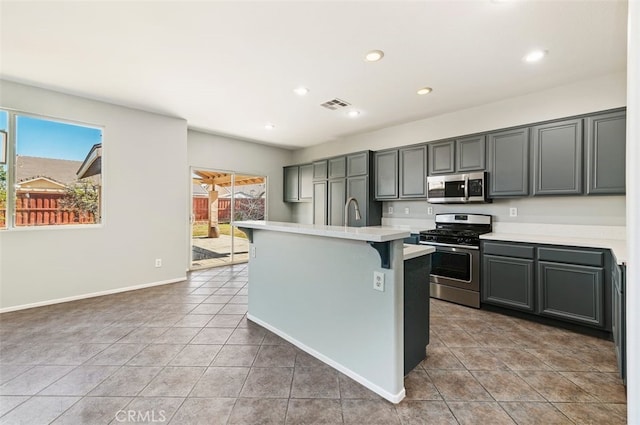 kitchen featuring stainless steel appliances, light countertops, visible vents, and plenty of natural light