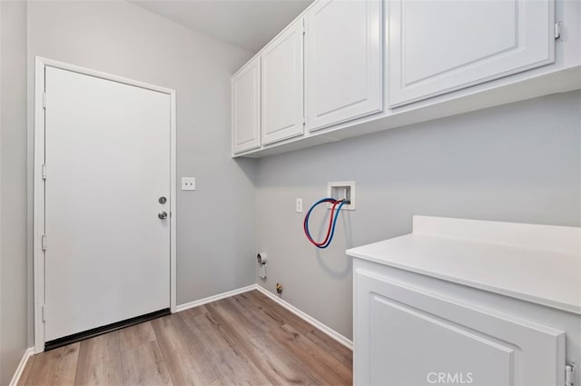 laundry room with washer hookup, hookup for a gas dryer, cabinet space, light wood-style flooring, and baseboards