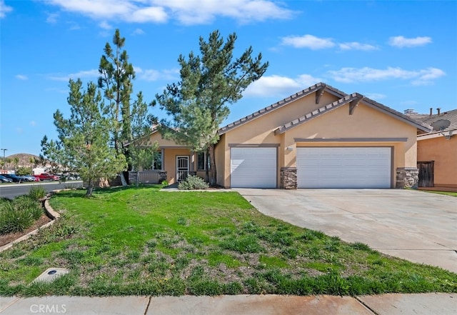 view of front of property with an attached garage, a front lawn, concrete driveway, and stucco siding