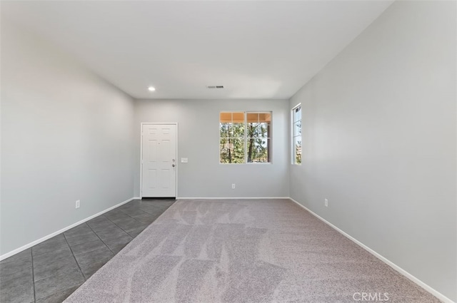 empty room with recessed lighting, tile patterned flooring, visible vents, and baseboards