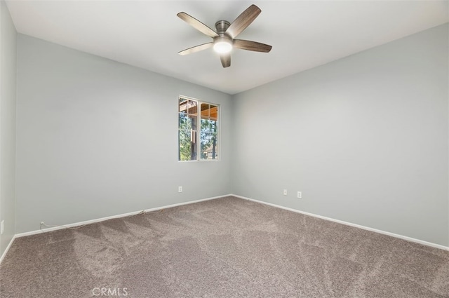 spare room with baseboards, a ceiling fan, and carpet flooring