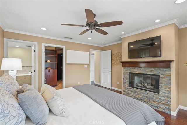 bedroom featuring visible vents, wood finished floors, crown molding, baseboards, and a spacious closet