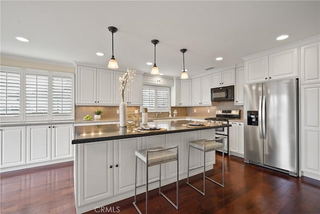 kitchen with white cabinets, dark wood-style floors, backsplash, and stainless steel appliances