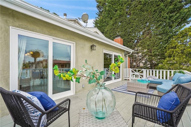 view of patio with an outdoor living space and a wooden deck