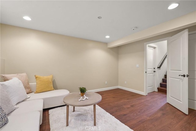 living area featuring recessed lighting, stairs, baseboards, and wood finished floors