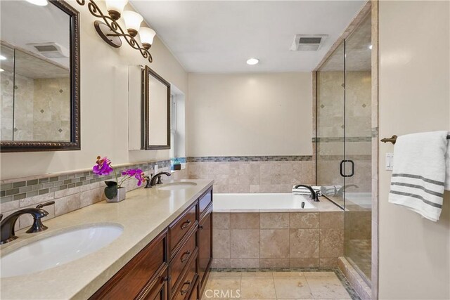 full bath with a sink, visible vents, a bath, and tile patterned floors