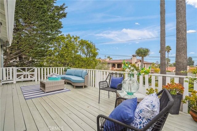 wooden deck with an outdoor living space