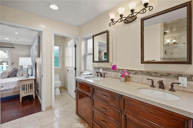 full bath with tile patterned floors, backsplash, and a sink