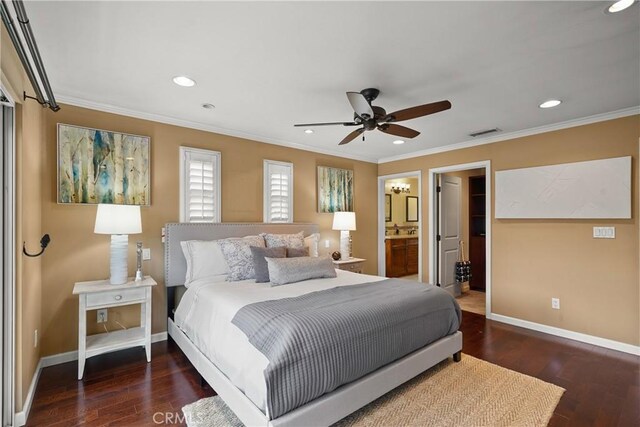 bedroom with visible vents, baseboards, wood finished floors, and ornamental molding