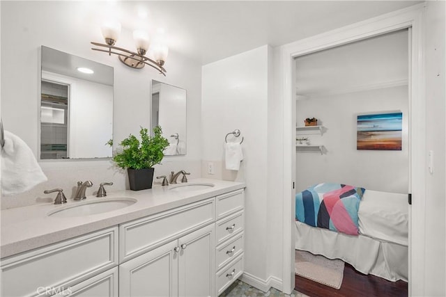 full bathroom with a sink, double vanity, and ensuite bathroom